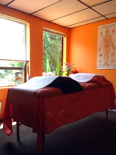 Acupuncture treatment room with orange walls
