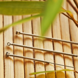 Acupuncture needles on bamboo mat